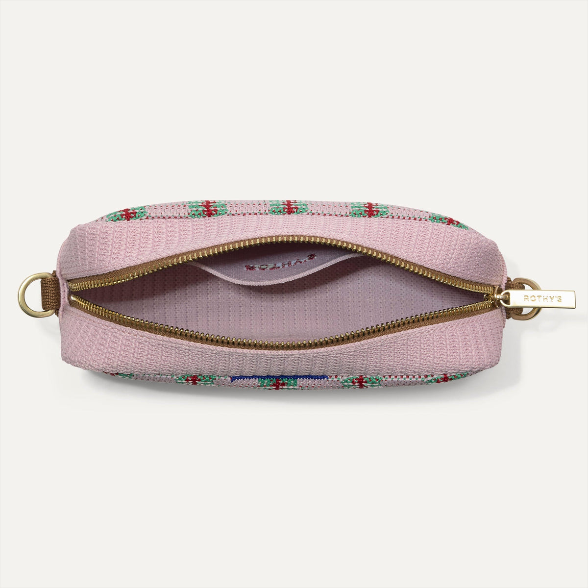 The Crossbody Camera Bag in Watermelon Market Stripe, shown from above, with the interior exposed.