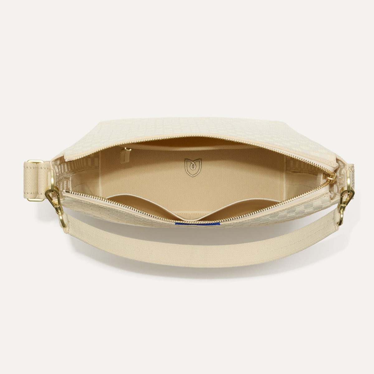 The Mini Zip Bucket in White Sand shown from the top down, with zipper open and interior exposed.