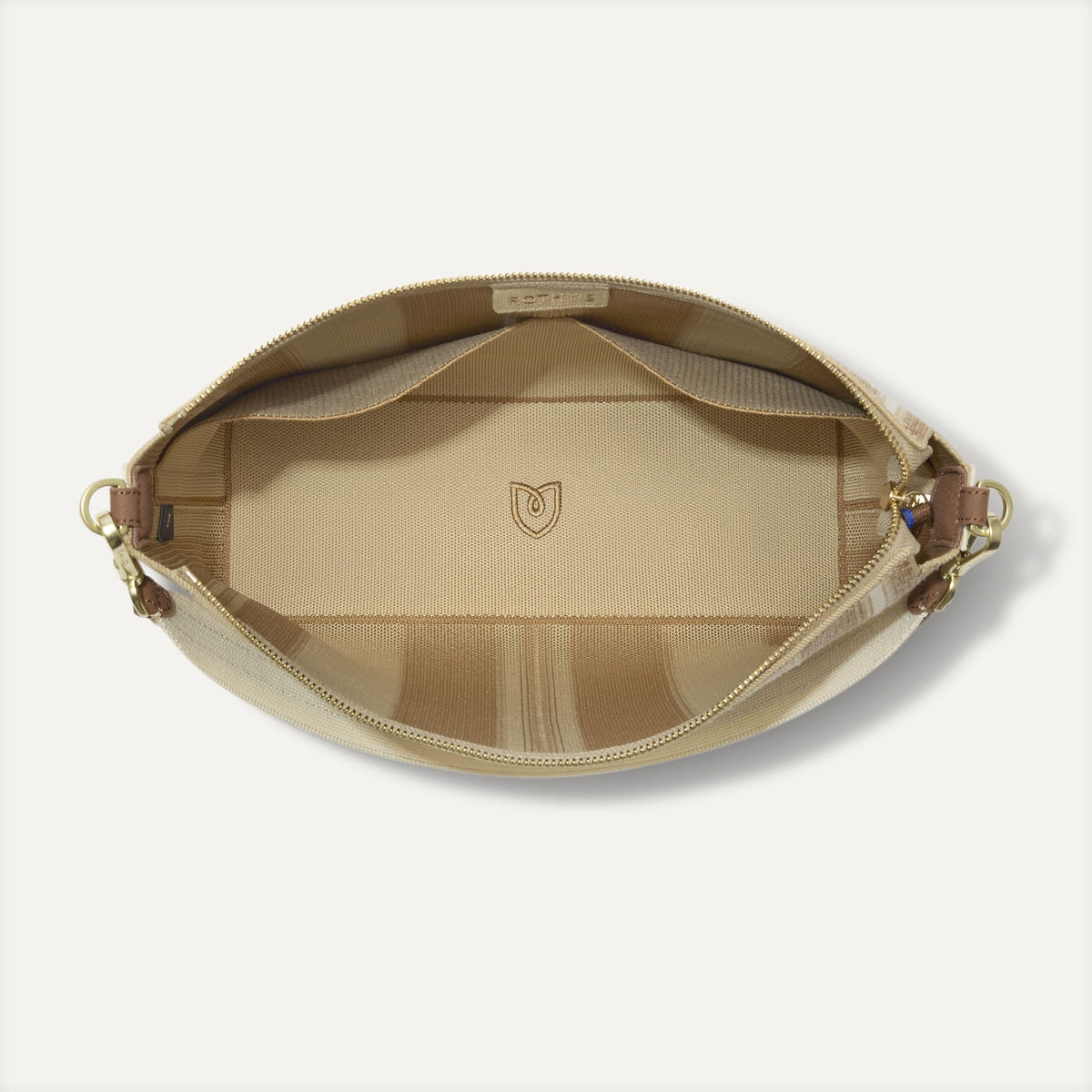 The Daily Crossbody in Oat Latte, shown from the top down, with zipper open and interior exposed.