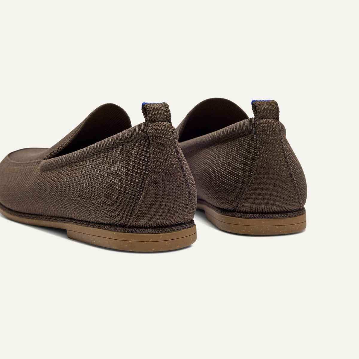 Close up of the heel of The Ravello Loafer in Dark Bistro, with Rothy's signature blue halo on the pull tab.