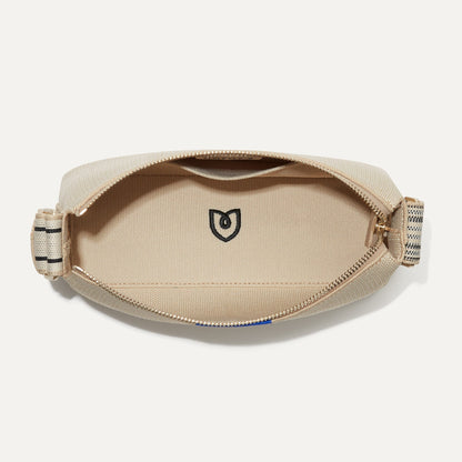 The Casual Crossbody in Parchment, shown from above, with the interior exposed.