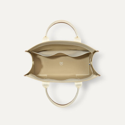 The Classic Tote in Buttercream, shown from above, with the interior exposed.