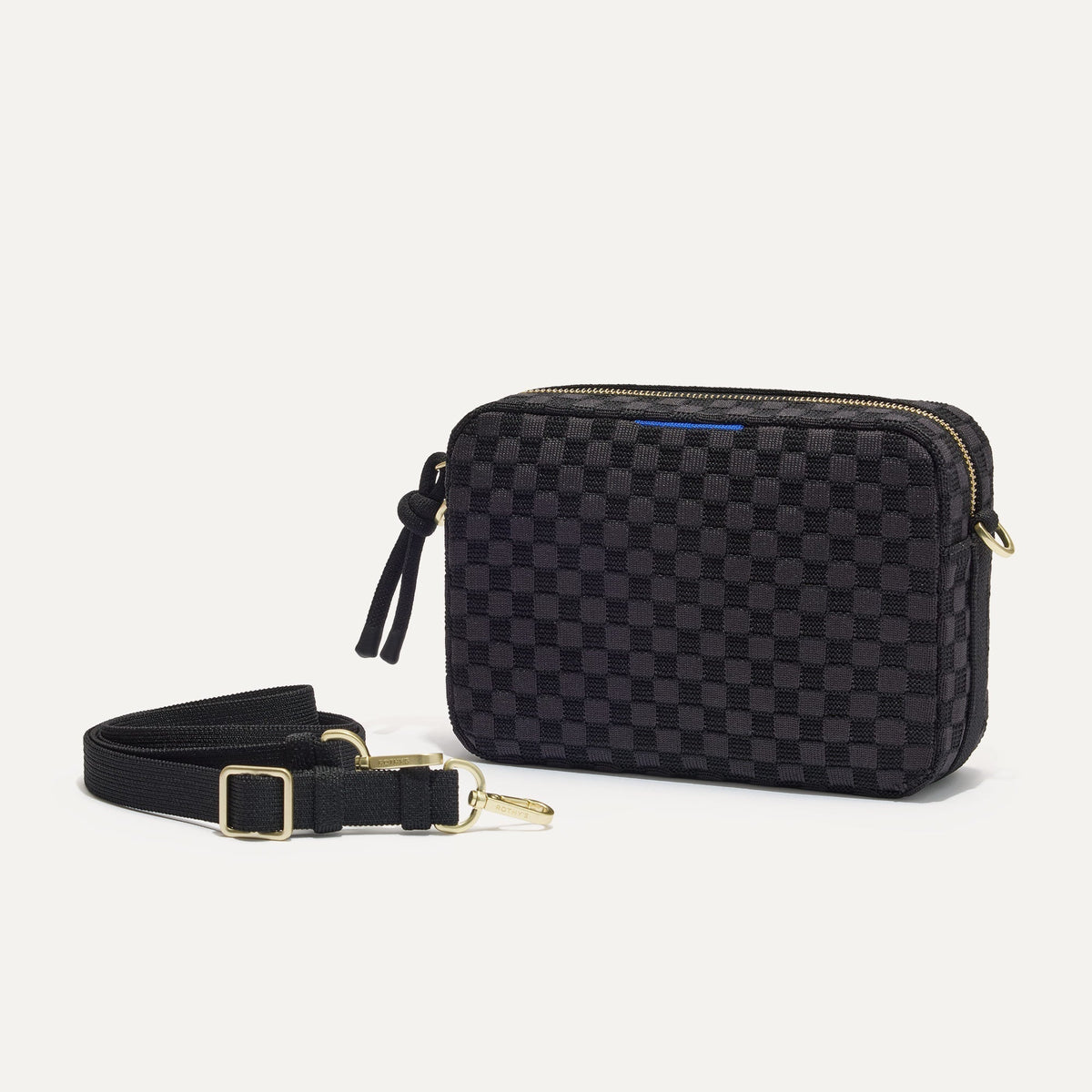 The Crossbody Camera Bag in Black Sand shown by itself with removable strap.