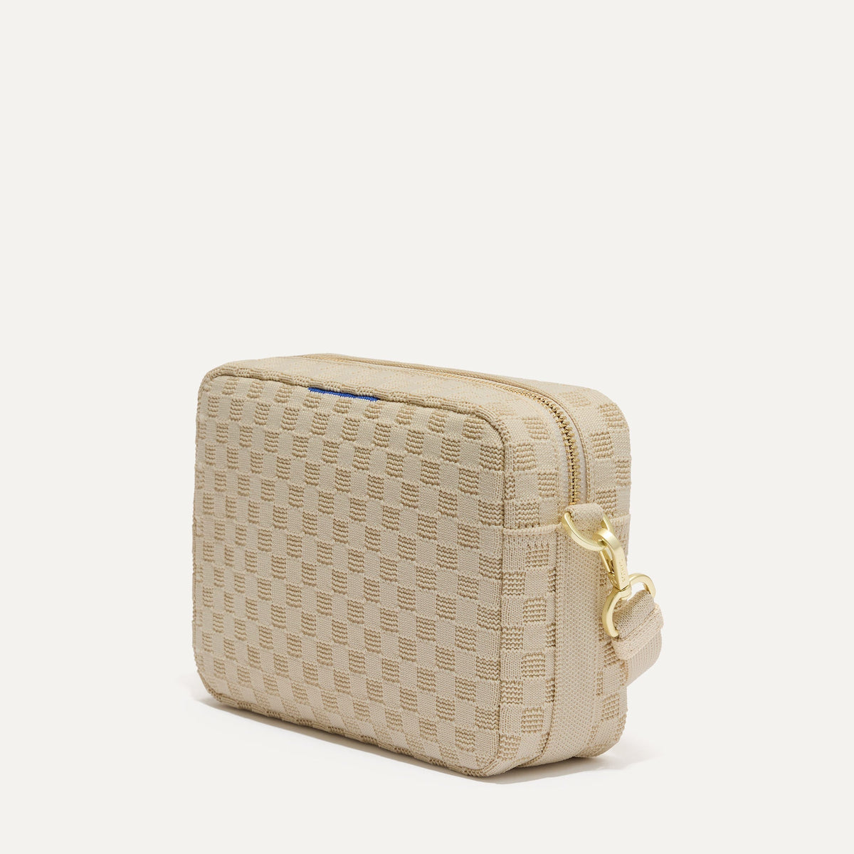 The Crossbody Camera Bag in Sesame, shown from the side.