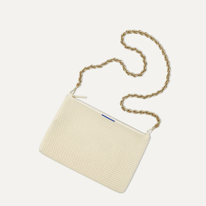 Overlay:: Shown with The Crossbody Strap (sold separately). | Alt:: An image of The Convertible Clutch in Love Bird Open Knit paired with The Crossbody Strap.
