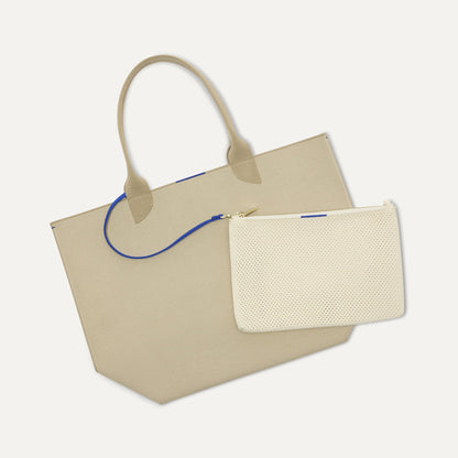 Overlay:: Clips onto The Lightweight Tote key leash. | Alt:: An image of The Convertible Clutch in Love Bird Open Knit clipped to The Lightweight Tote key leash.
