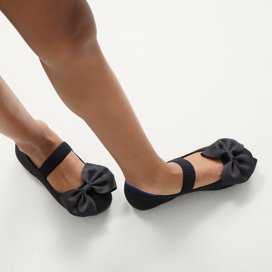 hover | Model wearing The Kids Big Bow Mary Jane in Black.