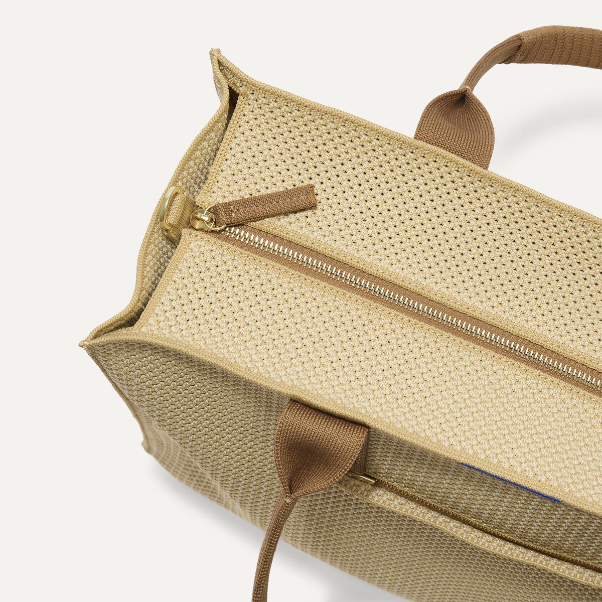 The Classic Tote in Macadamia Open-Knit, shown from above, with the top zipper closed.