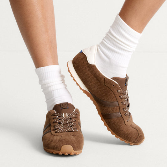 hover | Model wearing The Ivy Sneaker in ReVelvet Cinnamon.
