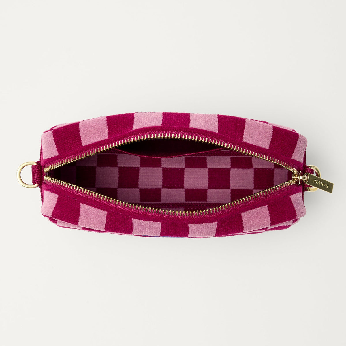 The Crossbody Camera Bag in ReVelvet™ Orchid, shown from above, with the interior exposed.