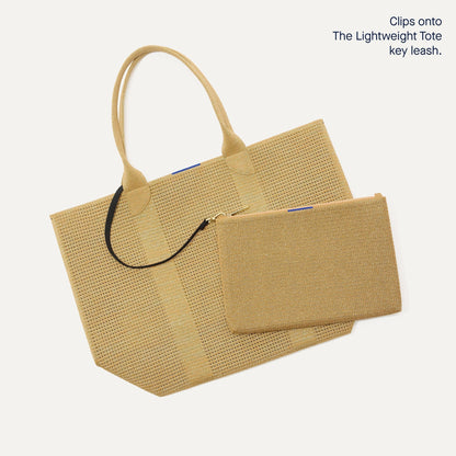 The Convertible Clutch in Glitzy Gold focusing on the strap.